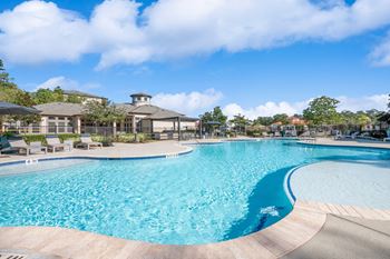 Resort-style swimming pool with tanning deck